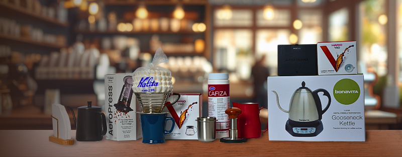 Collection of coffee-related products on a counter with a blurred cafe background
